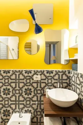 a bathroom with a sink and a yellow wall at YCH-Belle Epoque House in Rome