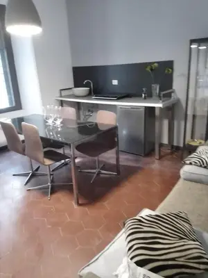 a living room with a glass table and chairs at Hostapartment SUITE UP in Rome