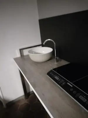 a kitchen counter with a sink and a bowl on it at Hostapartment SUITE UP in Rome