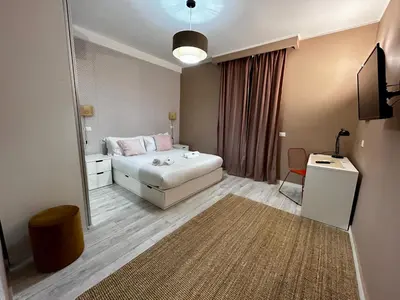 a bedroom with a bed and a desk and a mirror at Provincie 55 in Rome