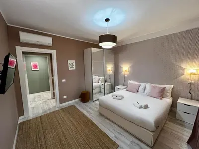 a bedroom with a white bed and a mirror at Provincie 55 in Rome