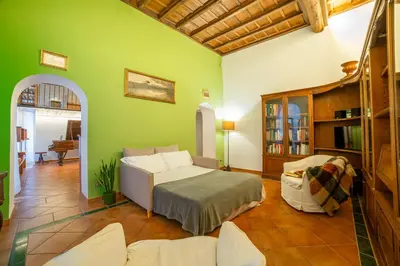 a bedroom with a bed and a green wall at Borgo Pio 64 - Vatican City in Rome