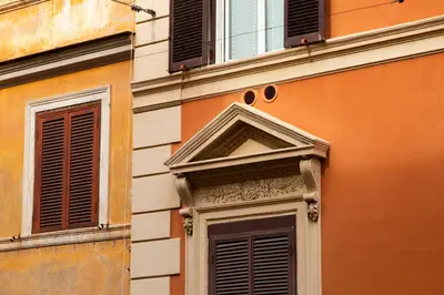 an orange building with windows and a door at Borgo Pio 64 - Vatican City in Rome