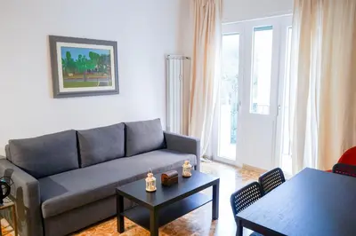 a living room with a couch and a table at The Twenty - Vatican Apartment in Rome