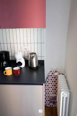 a kitchen with a counter top and a refrigerator at The Twenty - Mazzini apartment in Rome
