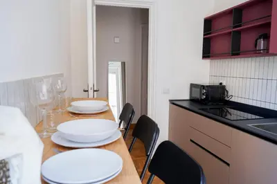 a kitchen with a table with white plates on it at The Twenty - Mazzini apartment in Rome