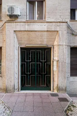 a building with a green door with a window at The Twenty - Mazzini apartment in Rome