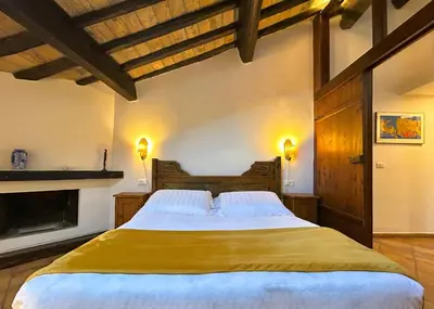 a bedroom with a large bed with a fireplace at The Gem - Trastevere Cozy Retreat with pool in Rome