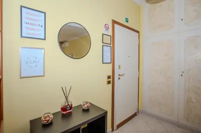 a hallway with a mirror on the wall and a table at Your Whole Suite in Rome