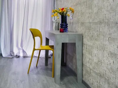 a table with a vase of flowers and two chairs at C'est La Vie Suites in Rome