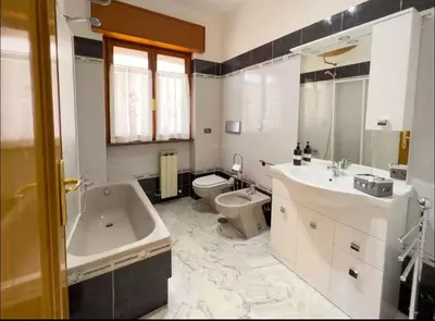 a bathroom with a tub and a toilet and a sink at Casa di Eli in Rome