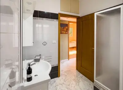 a bathroom with a sink and a shower at Casa di Eli in Rome