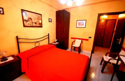 a bedroom with a red bed in a room at Ababaluba - Colosseo - San Giovanni in Rome