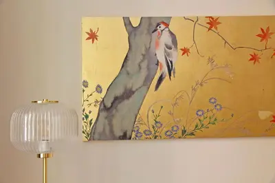 a painting of a bird perched on a tree at La Petite Urbana Apartment in Rome