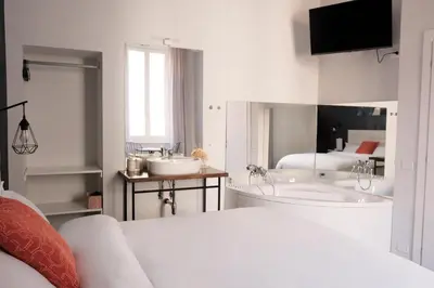 a white bathroom with two sinks and a tub at Numi B&B in Rome