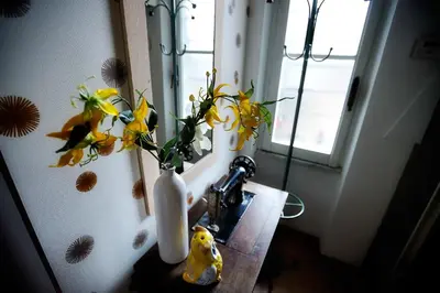 a vase of flowers on a sink in a bathroom at Appartamento Sofia in Rome