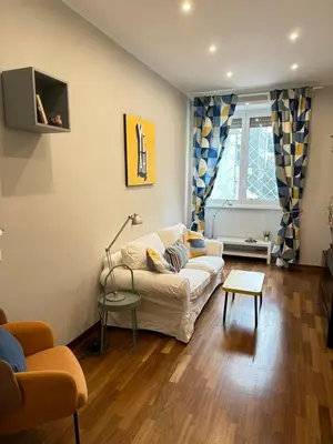 a living room with a white couch and a table at Botticelli 2 Guesthouse in Rome