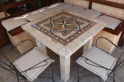 a table with four chairs and a star on it at Domus Corneliæ - Romantico Attico Roman & Jacuzzi - Metro A Cornelia in Rome