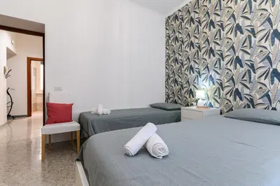 a bedroom with two beds with towels on them at Casa Ausilia in Rome