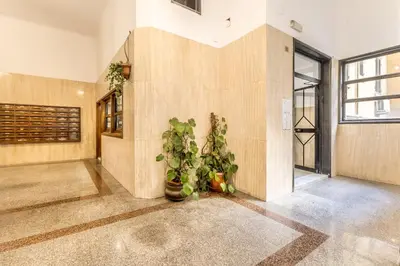 a lobby with plants in the corner of a building at Sapienza Apt - Modern House in Piazza Bologna in Rome