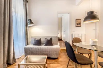 a living room with a couch and a table at Sapienza Apt - Modern House in Piazza Bologna in Rome