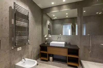 a bathroom with a sink and a toilet and a mirror at Castroni Ottaviano Suite in Rome