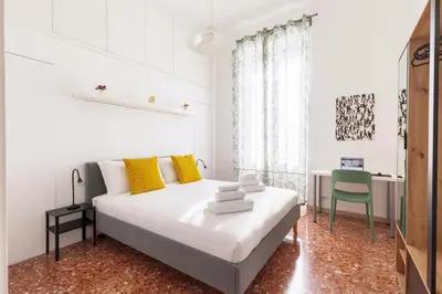 a white bedroom with a bed and a desk at Hostly-Maison Sant'Angelo-Few steps from Vatican in Rome