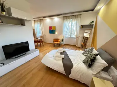 a bedroom with a large bed and a flat screen tv at Angolo al Vignola in Rome