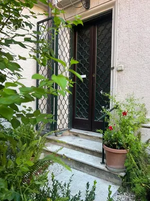 a front door of a house with stairs and flowers at Belle Arti Home in Rome