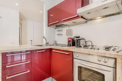 a kitchen with red cabinets and a stove at CasaTrastevere Alessio&Simone in Rome