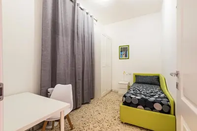 a bedroom with a bed and a table and a desk at Al posto di Luca in Rome