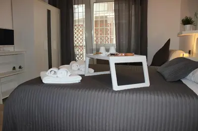 a bedroom with a bed with towels and a table at The house of St. Peter in Rome
