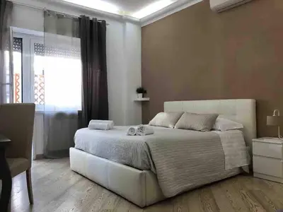 a bedroom with a white bed and a window at The house of St. Peter in Rome