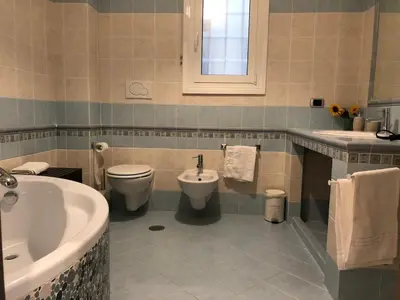 a bathroom with a tub and a toilet and a sink at The house of St. Peter in Rome