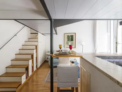 a kitchen with a table with a glass of wine at Apartment Marsicum by Interhome in Rome