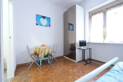 a living room with a table and a dining room at Guest House Piazza Tarquinia in Rome