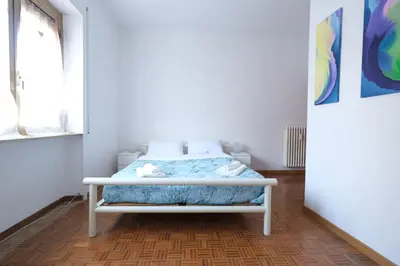 a bedroom with a bed in a room with a window at Guest House Piazza Tarquinia in Rome