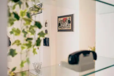 a room with a glass table with a picture on the wall at RHOME - Luxury Sharing Home in Rome