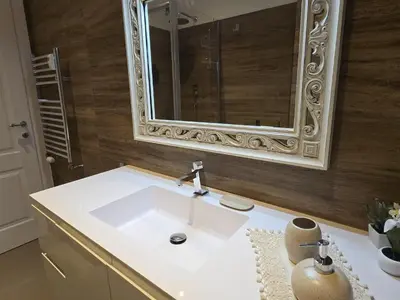 a bathroom with a white sink and a mirror at RHOME - Luxury Sharing Home in Rome