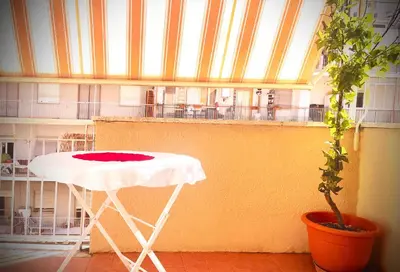 a white table in a room with a plant at RHOME - Luxury Sharing Home in Rome