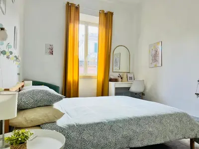 a bedroom with a bed and a table and a mirror at VerdePigna Apartment in Rome