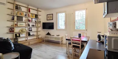 a living room with a table and a television at Terracehome71 - Apartment with relaxing terrace near Vatican in Rome