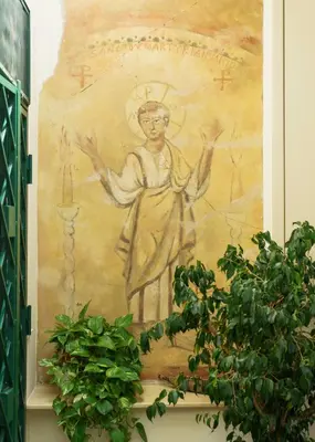 a painting of a statue on a wall with plants at Villa Mara Appia antica in Rome
