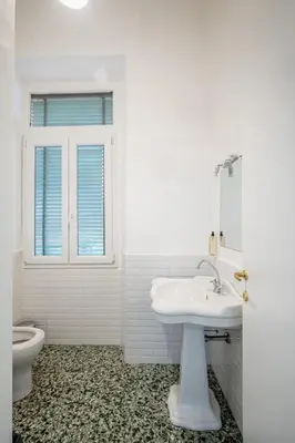 a white bathroom with a sink and a toilet at My Tiny Home Alchemy in Rome