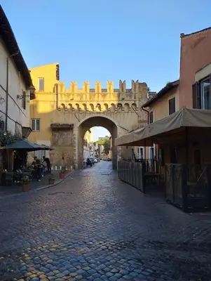 an archway over a cobblestone street in a city at Angolo dè Trastevere - Accogliente e silenzioso in Rome