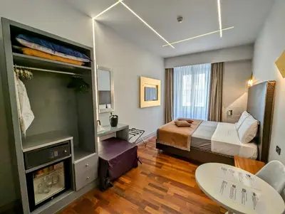 a hotel room with a bed and a tv at Affittacamere RFI in Rome