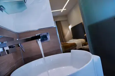 a bathroom with a sink with water coming from a faucet at Affittacamere RFI in Rome