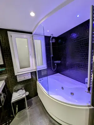 a bathroom with a large tub and a sink at Affittacamere RFI in Rome