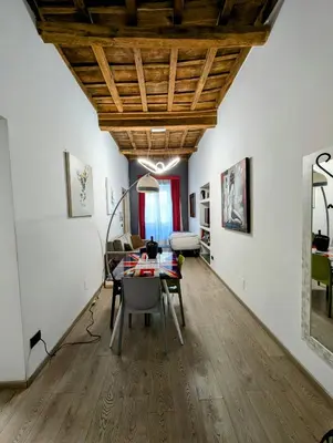 a dining room with white walls and a wooden ceiling at Domus Forus in Rome