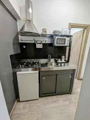 a small kitchen with a sink and a stove at Domus Forus in Rome